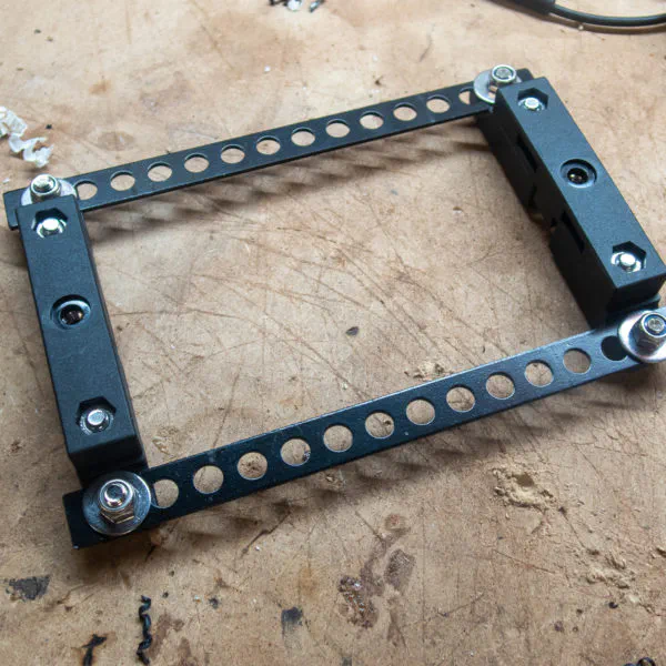 Brack­ets fit­ted to steel cross-sec­tions to allow for zip tying/bolting to the rack.